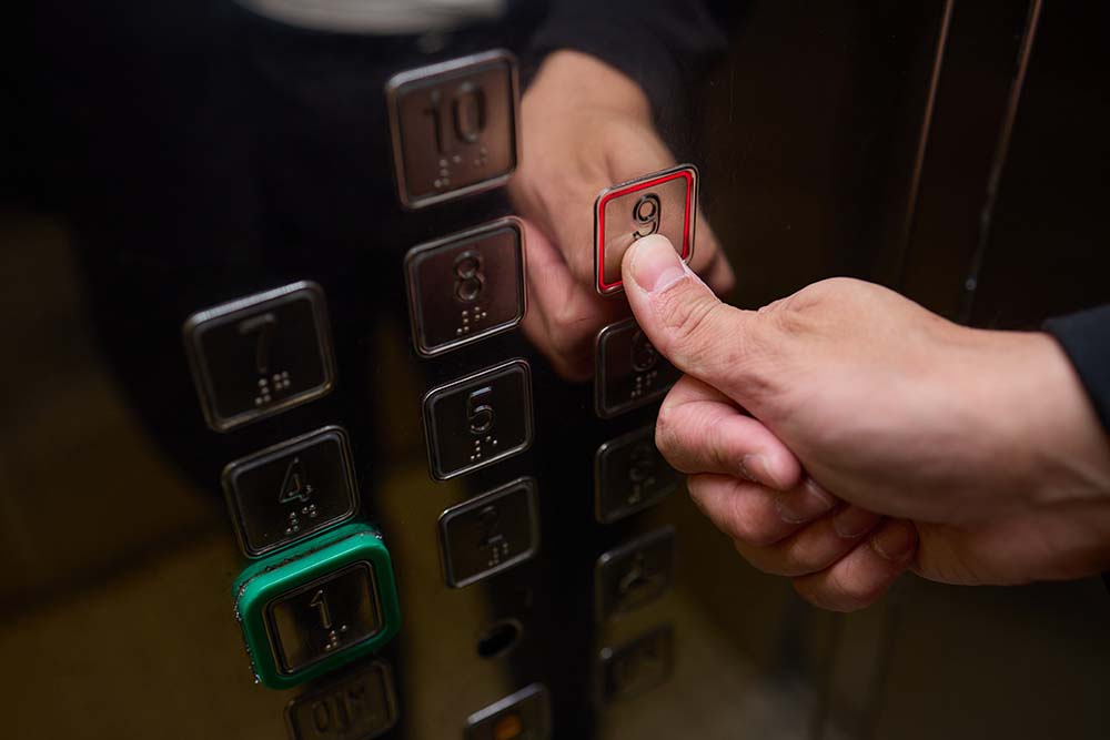 CloseUp of Hand Pressing Elevator Button Person Operating Modern Building Lift elevator access control turnstile for business and public property security, gta access control,P8MX+GC Brampton, Ontario