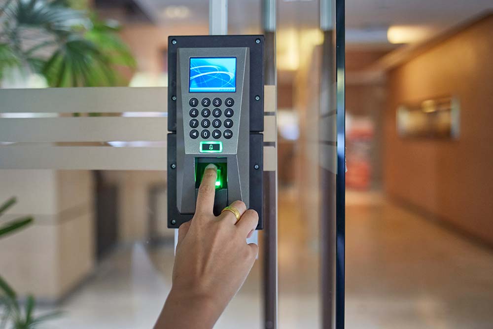 Man or woman push finger down on electronic control machine to access Control systems, touch controls, commercial security, P8MX+GC Brampton, Ontario