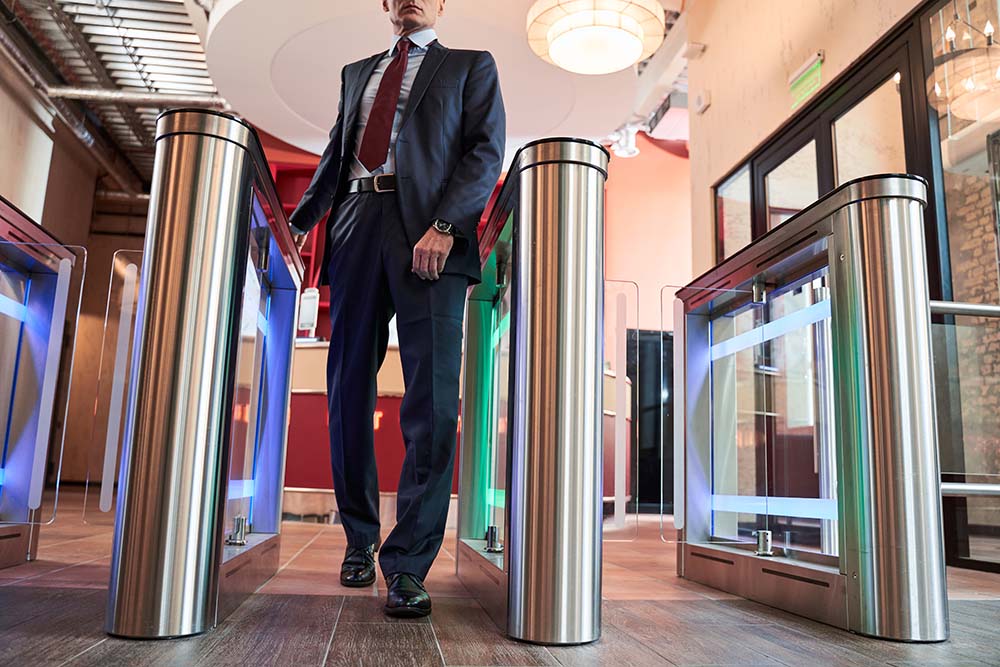 Man entering office via turnstile entrance control turnstile for business and public property security, gta access control,P8MX+GC Brampton, Ontario
